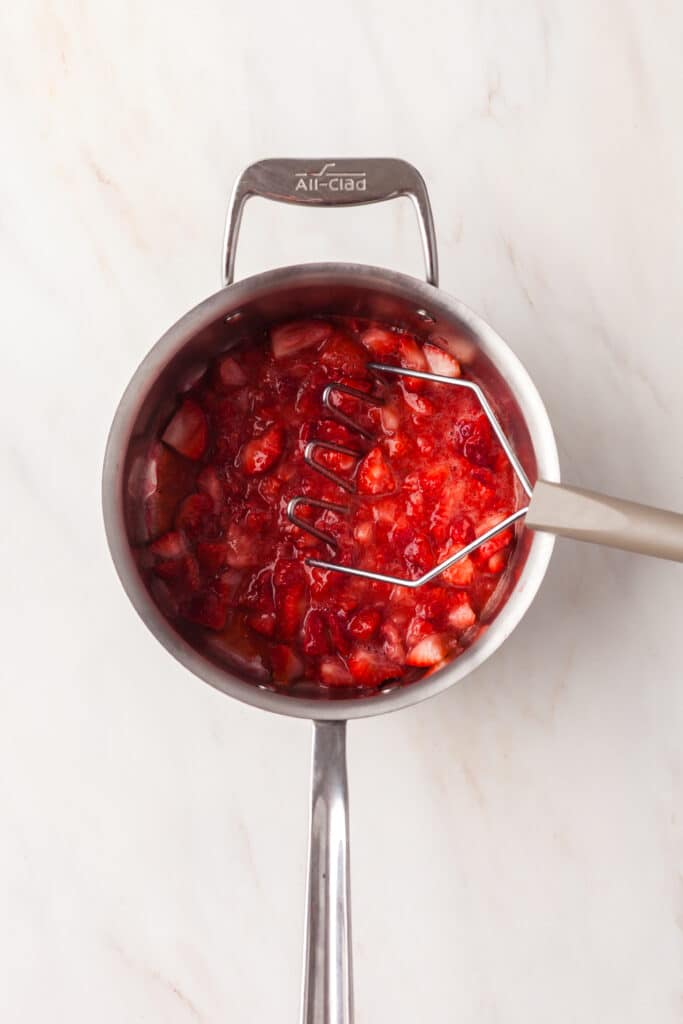 process shot of how to make strawberry chia seed jam.