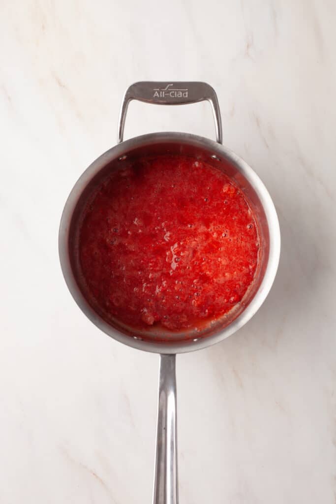 process shot of how to make strawberry chia seed jam.