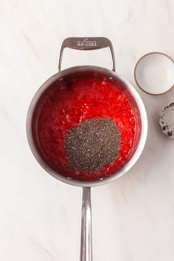 process shot of how to make strawberry chia seed jam.