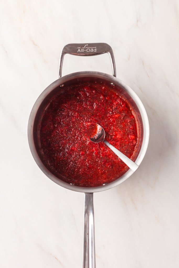 process shot of how to make strawberry chia seed jam.