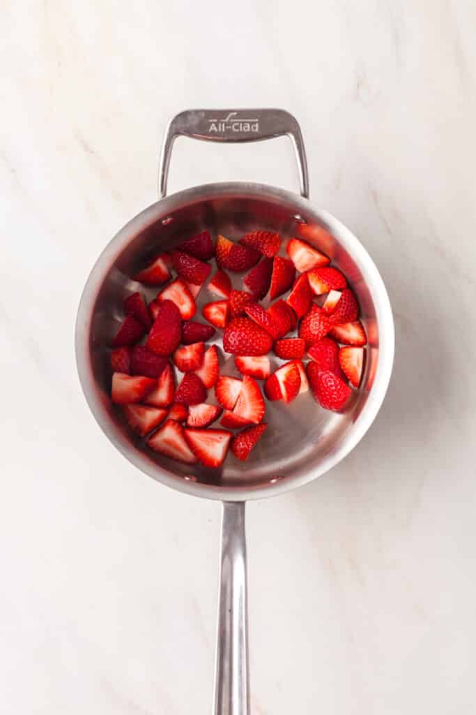 process shot of how to make strawberry chia seed jam.