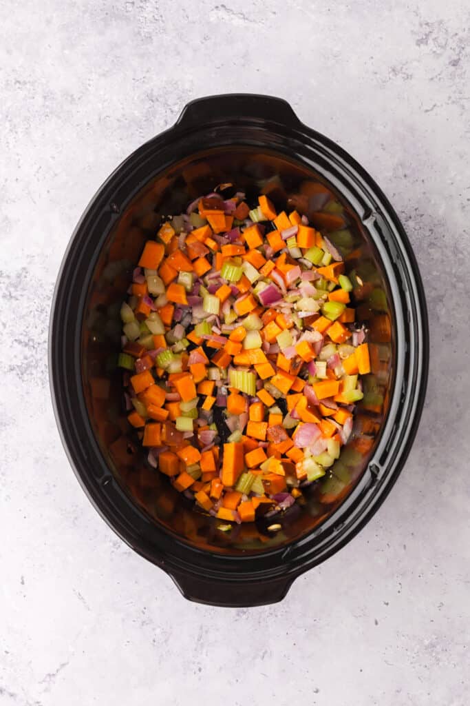process shots of a golden chickpea and veggie soup in a crockpot.
