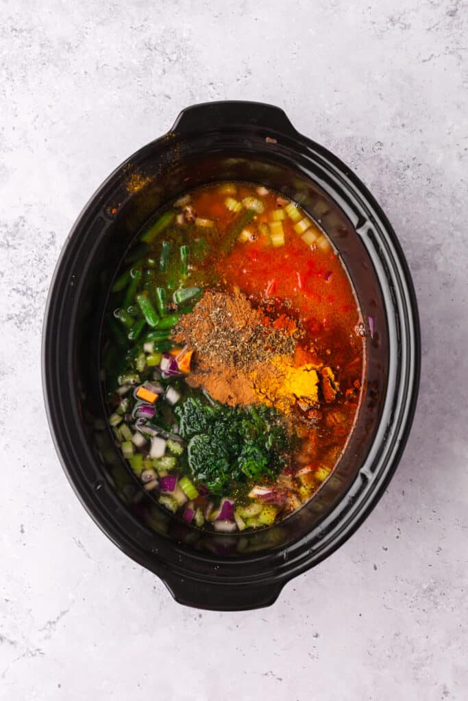 process shots of a golden chickpea and veggie soup in a crockpot.