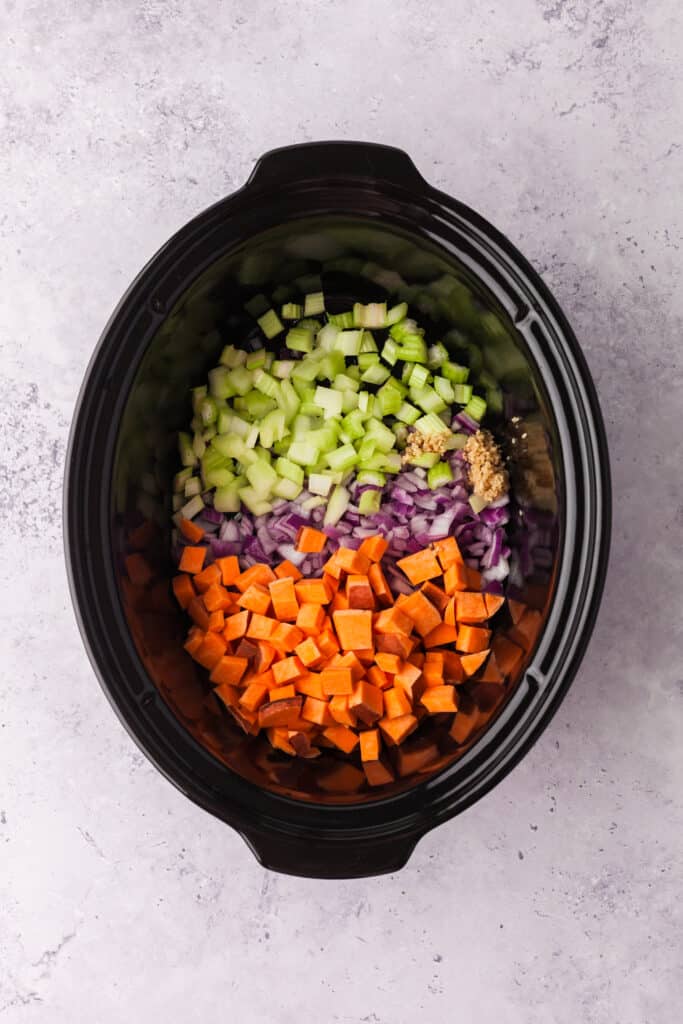 process shots of a golden chickpea and veggie soup in a crockpot.