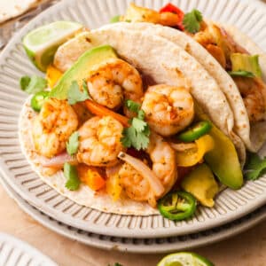shrimp fajitas in tacos with cilantro and jalapenos.