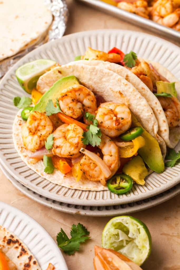 shrimp fajitas in tacos with cilantro and jalapenos.