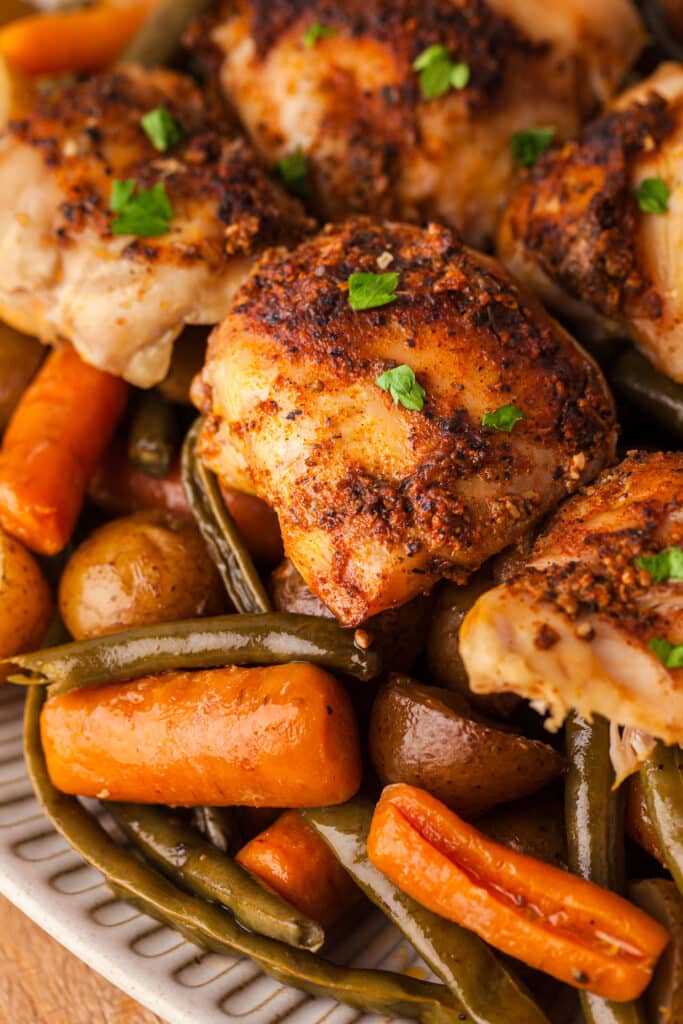 closeup of cooked crockpot chicken, potatoes, and veggies meal.