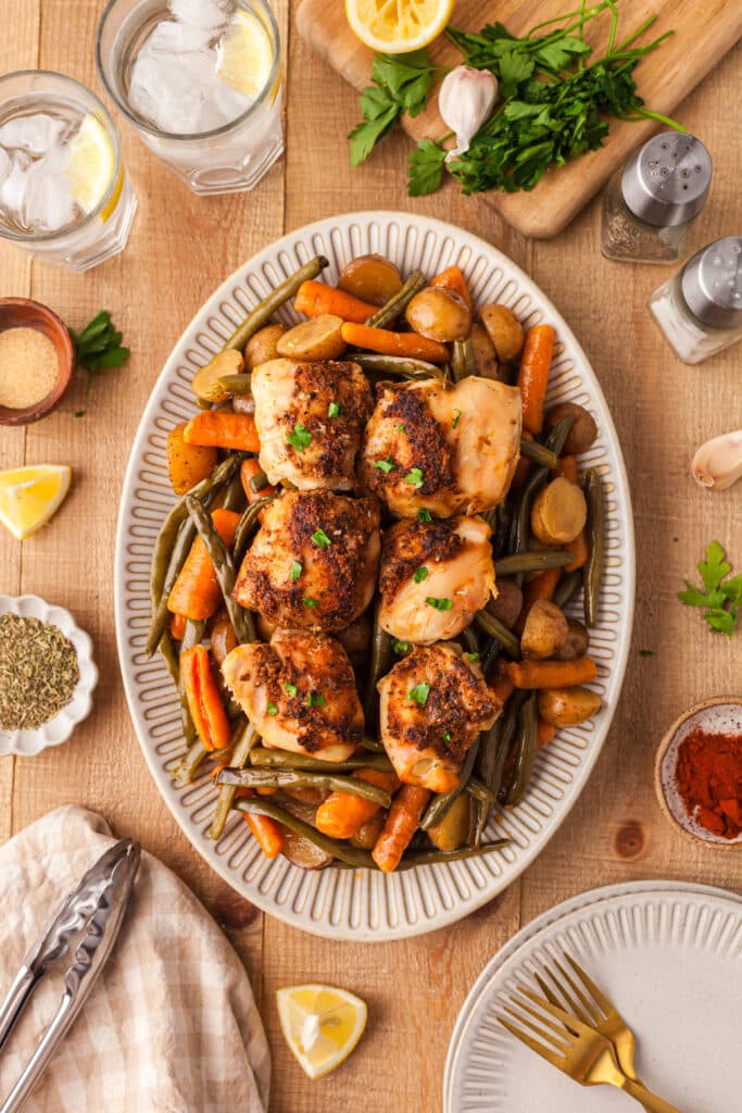 crockpot chicken, potatoes, green beans, and carrots on a large white serving platter.