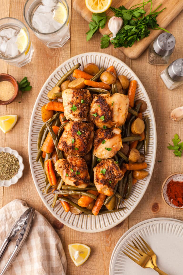 crockpot chicken, potatoes, green beans, and carrots on a large white serving platter.