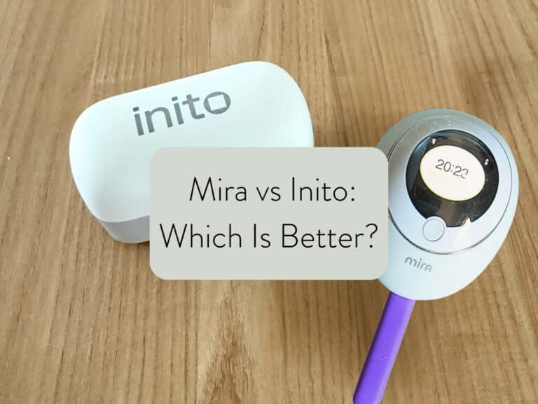 inito fertility monitor and mira fertility monitor sitting on wooden countertop with text overlay: mira vs inito: Which is better?