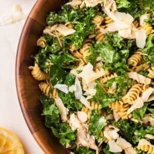kale pasta caesar salad in wood bowl.