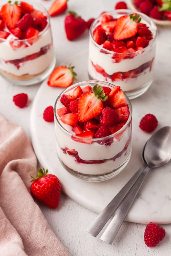 layered protein cheesecake cup with strawberries in a glass jar.
