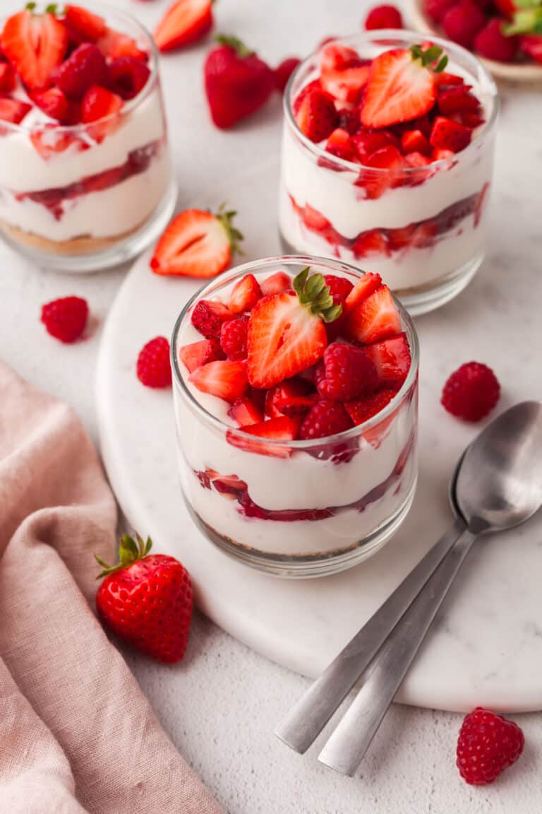 layered protein cheesecake cup with strawberries in a glass jar.