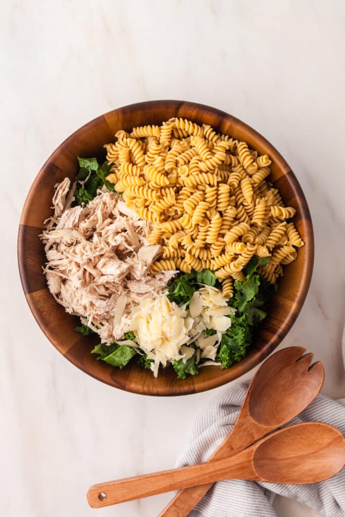 process shots on how to make a kale pasta caesar salad.
