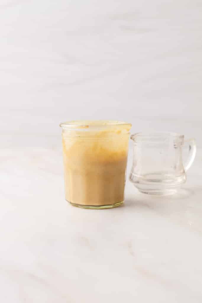 process shots of a salad dressing being made.