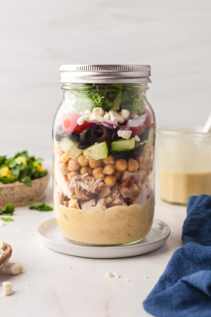 mason jar salad on a white countertop.